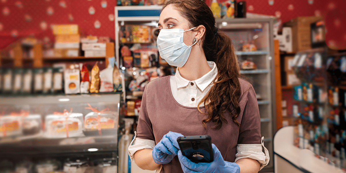 female manager in store wearing mask and gloves