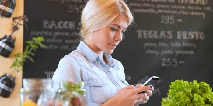 female waiter looking at phone