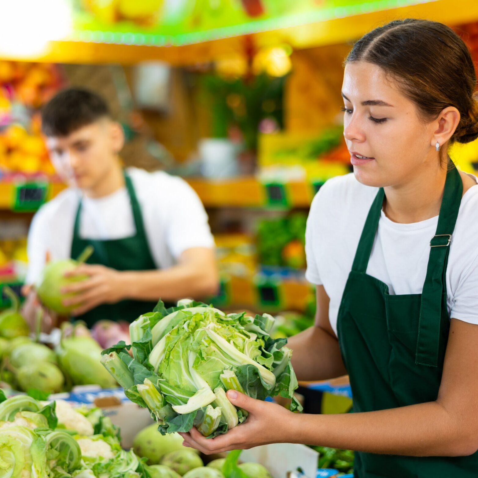 Supermarket,Female,Employee,Lays,Out,Fresh,Cauliflower,On,Shelves,In